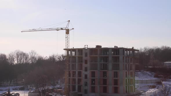 Construction site with big tower crane in time lapse with cloudscape.