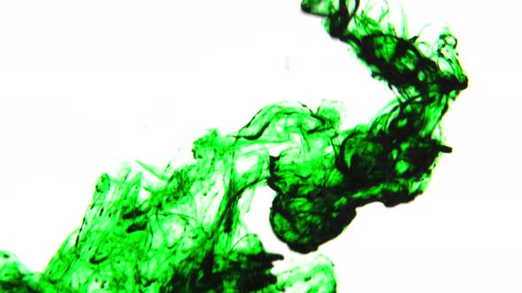 Green ink flowing underwater