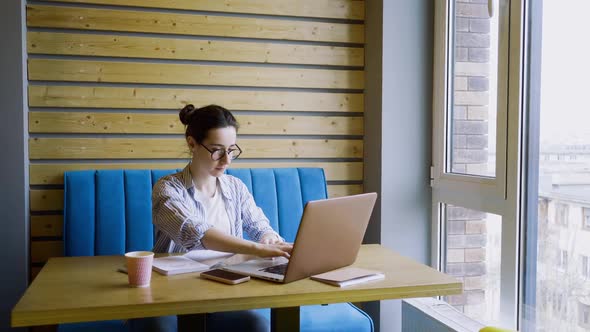 Young Woman Work on Laptop and Take Break in Cafe