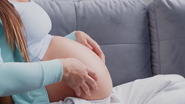 Young pregnant woman is resting at home and expecting a baby.
