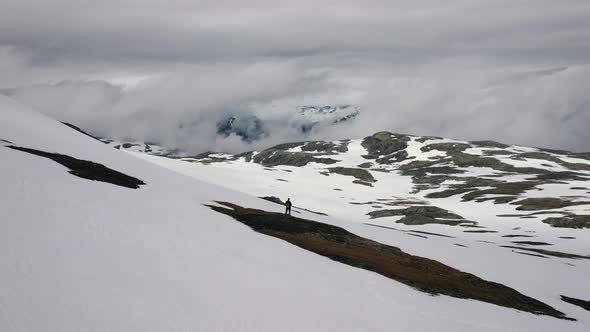 Aerial View Of Male Standing On Snow Covered Store Ishaug Mountain, Hardangervidda National Park, Ei