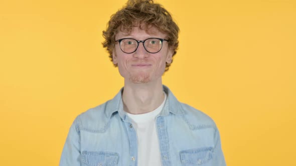 Redhead Young Man Laughing on Joke Yellow Background