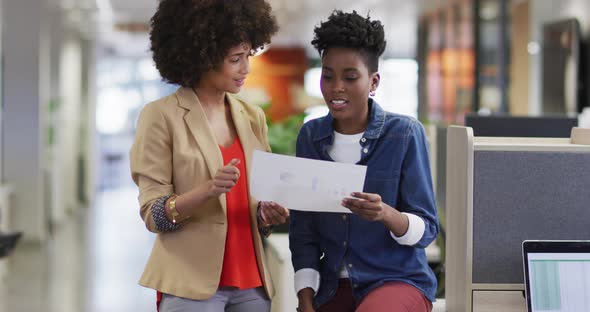 Video of diverse businesswomen working on project and talking