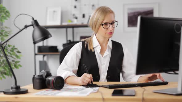 Woman Retouching Photos at Office