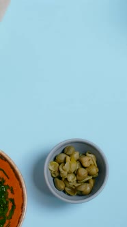 Vertical Tabletop Video Chef Puts Plate with Coocked Sweet Pea Pods to the Table