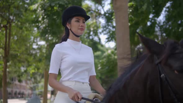 Pretty Young Lady in Black Helmet Horseriding in Park on Sunny Day Great Way To Have Equestrian