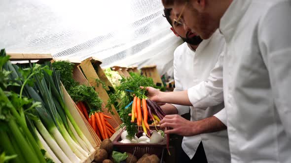 Men choosing vegetables for cooking