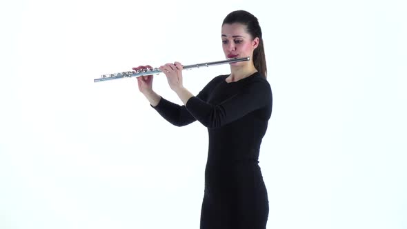 Girl Musician Playing on Flute Standing Sideways in Slow Motion