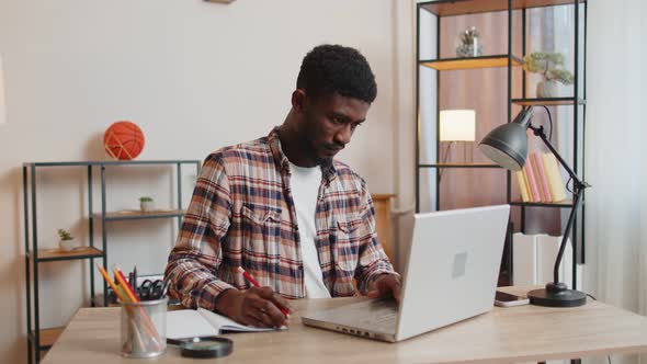 Young Man Guy Using Laptop Computer Sitting at Table Working Online Shopping From Home Office