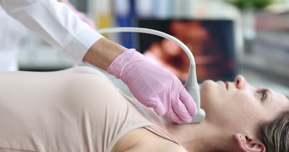 Doctor Making Ultrasound of Thyroid Gland and Cervical Lymph Nodes to Woman Patient in Clinic  Movie