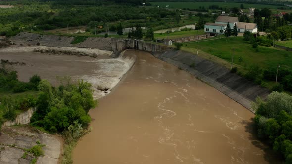 Aerial Drone View. River Water Move Down From with a Water Filled Dam After Heavy Floods and Rains