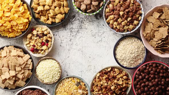 Assortment of Different Kinds Cereals Placed in Ceramic Bowls on Table