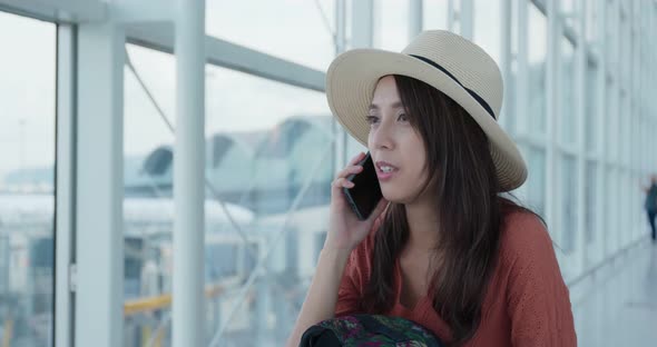 Woman talk to cellphone in the airport