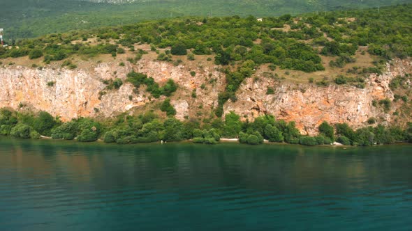 Aerial shot of Macedonia coast. Clif and beautiful water around Ohrid Lake in Southern Europe.