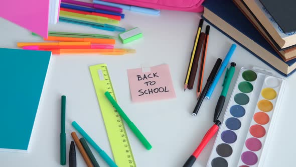 Closeup of Pupil Takes School Supplies From Table