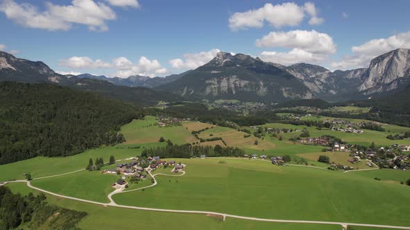 Aerial view of the village, fields and forest in mountains Alps Austria