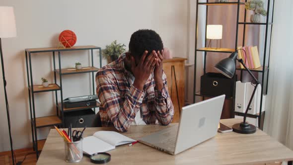 Tired Man Teacher Using Laptop Computer Suffering From Tension Migaine Headache at Home Office