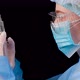 Side View of a Professional Female Doctor Holds a Syringe with a Vaccine - VideoHive Item for Sale