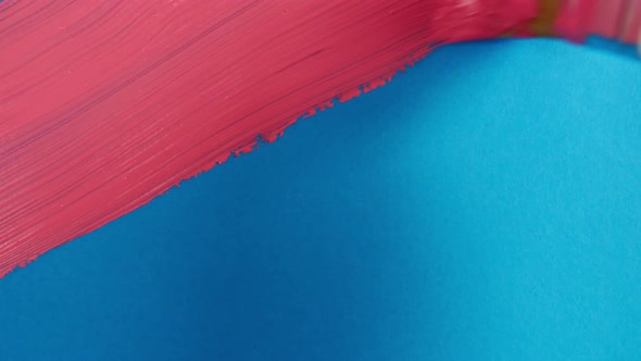 Abstract Brushstrokes of Pink Paint Brush Applied Isolated on a Blue Background