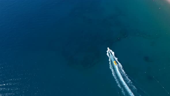 Aerial View Banana Riding With A Boat