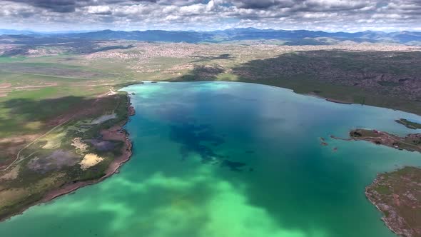 Gorgeous Turquoise Blue Green Lake Waters On Plain In Low Hilly Terrain Geography