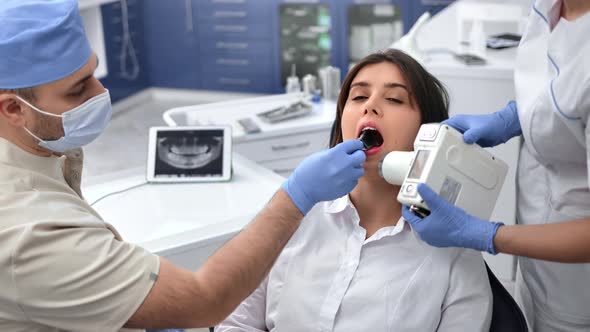Professional Stomatologist Male Doctor and Female Assistant Roentgen Shooting Mouth Cavity Patient