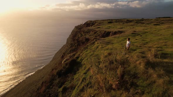 Male on Cliff Looking Into Future at Susnet