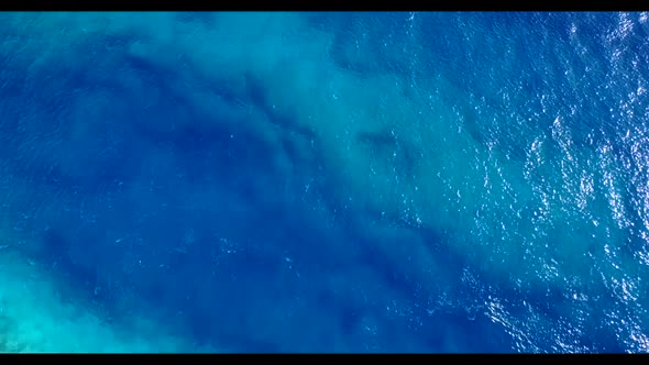 Aerial top down sky of idyllic tourist beach break by transparent ocean and white sand background of