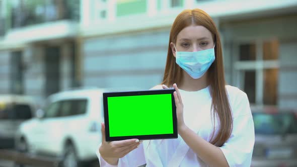 Teenage Girl in Protective Mask Holding Green Screen Tablet, Flu Prevention Tips