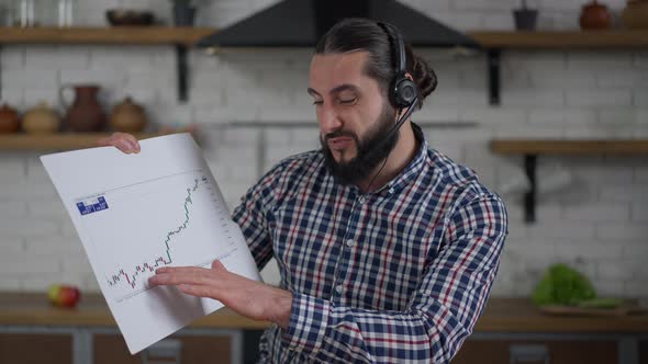 Web Meeting POV of Confident Professional Middle Eastern Man in Earphones Talking Pointing at Graph