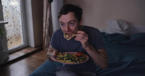 Man Eats Meat and Watches Tv at Home