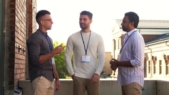 Businessmen with Name Tags Talking Outdoors