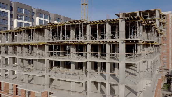 Building crane and monolituc building under construction. Construction site