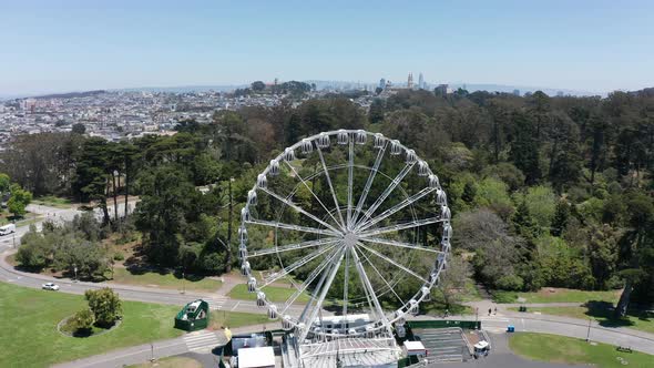 Push-in aerial shot of the SkyStar Ferris Wheel in Golden Gate Park, San Francisco. 4K