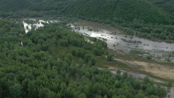 Flying above river floods after heavy rain 4K aerial video