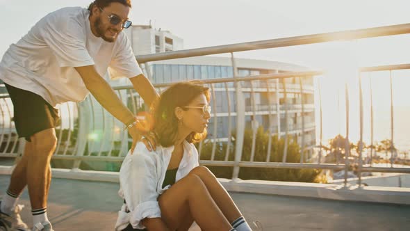 Man Pushing His Girlfriend on Longboard Sun Flare Slow Motion