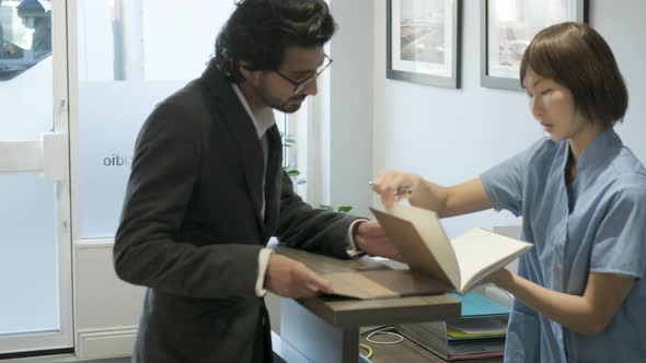 Patient writing in notebook at front desk