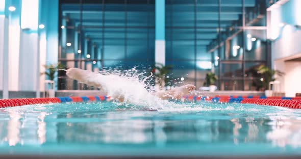 Female Swimmer in the Swimming Pool Perform the Elements of Synchronized Swimming View of Legs