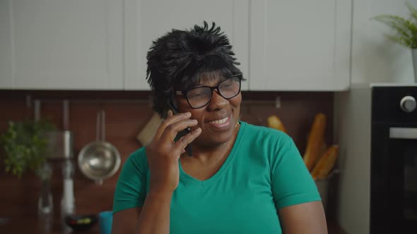 Lovely Senior Black Female Talking on Phone at Home
