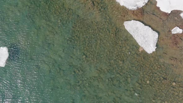 Flying Over Lake Superior With Floating Ice In Duluth, Minnesota - aerial top down