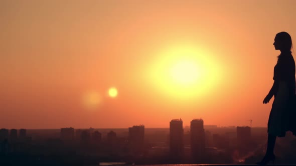 Female Celebrating Success at Sunrise in Town