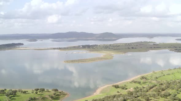 Aerial drone view of the reflection of the cloudy sky on the alqueva dam lake in Monsaraz