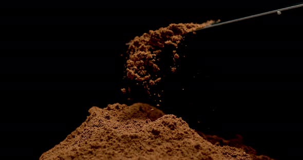 Nutmeg, myristica fragans, Powder falling against Black Background, Slow Motion 4K