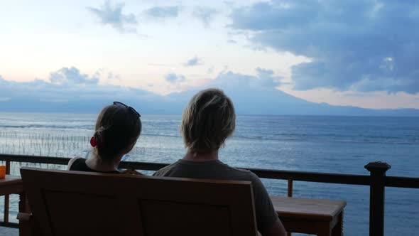 Young Couple Looking on Volcano and Ocean