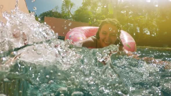  Young Girl in Sprinkled Donut Float at Pool