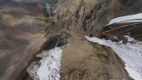 Aerial View Dive From Peak Natural Snowy Cliff Formation Summit at Canyon Valley Scenery Environment