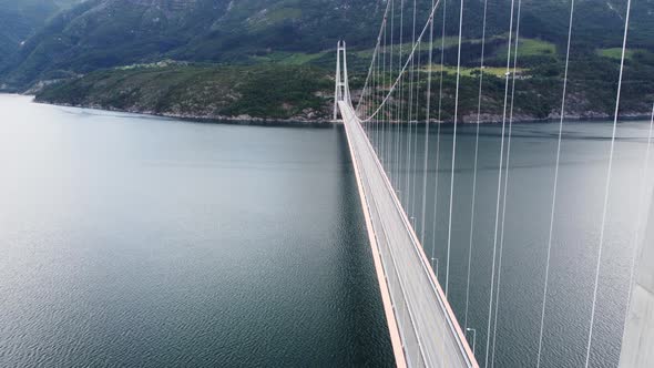 Descending aerial close to concrete column at Hardanger suspension bridge - Panoramic view over one