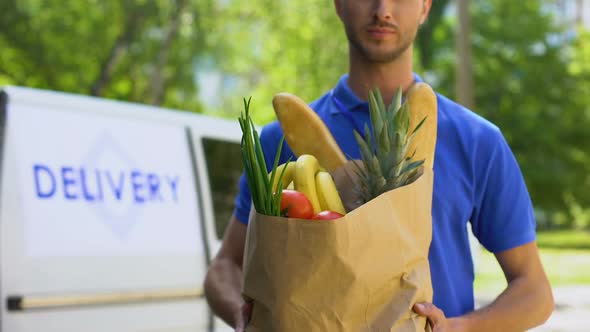 Young Deliveryman Showing Grocery Bag, Store Service, Online Order Shipment