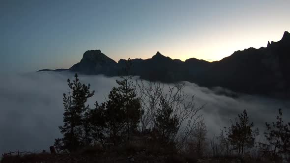 Sunrise time lapse in the mountains over the fog