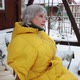 Adult Woman Sways on a Swing and Looks Alone Into the Distance Around the Snow - VideoHive Item for Sale